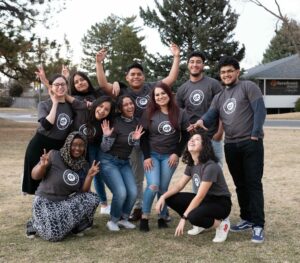 Group of Denver students smiling and clowning around outside